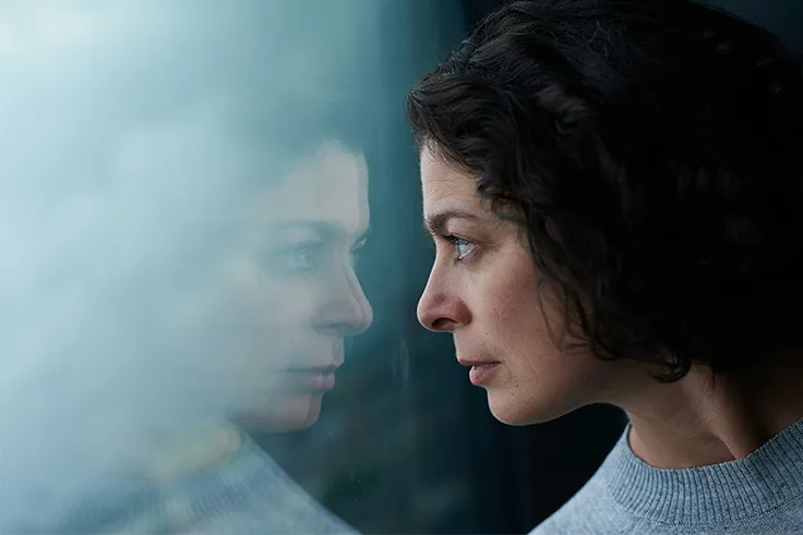woman staring at reflection